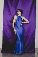 Magnificent purple fitted sheath gown with extreme low cut back.