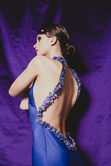 Magnificent purple fitted sheath gown with extreme low cut back.