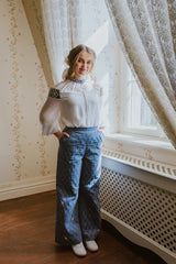 Swan blue velvet wide trousers, with crossed silver thread stitching.