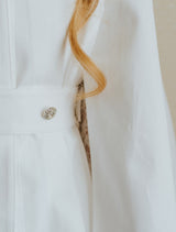 Dreamy denim pleated cape in ivory white tone.