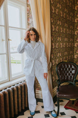 White denim boot-leg trousers with two side pockets, button and zipper in the front.