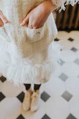 Above knee skirt with swan feathers and tweed fringe.