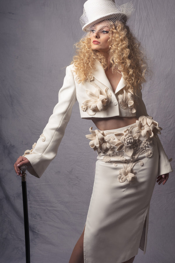 white jacket and skirt set adorned with three-dimensional crochet flowers
