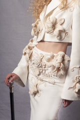 white jacket and skirt set adorned with three-dimensional crochet flowers