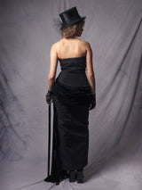 off-shoulder black dress withs a beaded corset top and a silk velvet basque, accentuated by a high slit