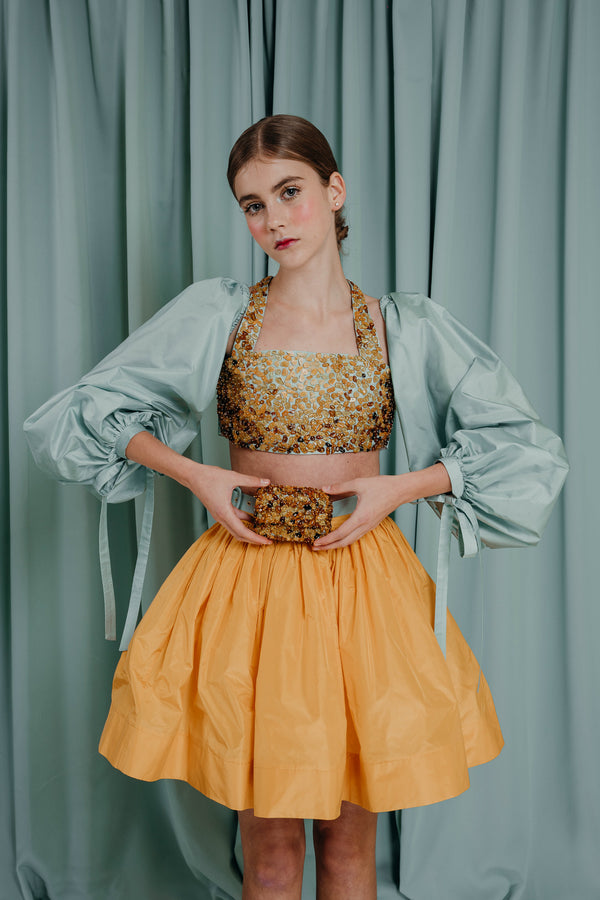 Cropped statement top in fine silk taffeta with gorgeous bishop sleeves and royal natural amber-embroidered bodice. Each unique piece of amber is pierced by a master jeweller and hand-sewn, using a gilded bead.