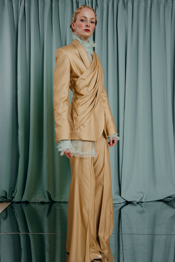 couture clothing Magnificent full length suit jacketin warm gold with a shawl lapel. The jacket has a beautiful draped detail in the front that follows onto the back.