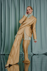 couture clothing full length suit jacketin warm gold with a shawl lapel. The jacket has a beautiful draped detail in the front that follows onto the back.