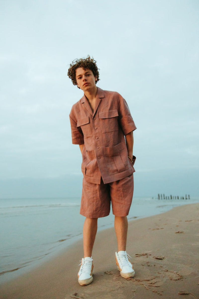 Relaxed-fit, wide-leg linen shorts with front button closure and two silk-lined pockets.