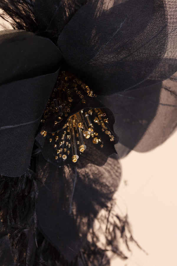 Beautifully crafted black daffodil pin in 100 % silk and gilded bead and ostrich feather trim.