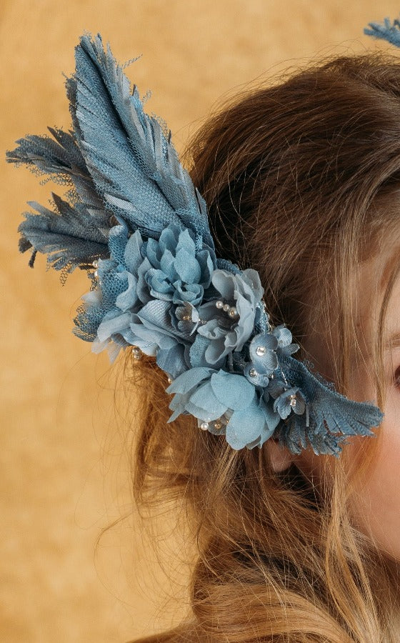 Delicate blue swan feather accessory with crystals.