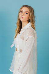 Elegant soft white, transparent organza blouse with button closure on the front.