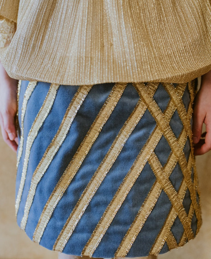 Royal velvet midi skirt with crossed golden ribbon stitching.