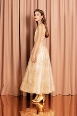 Magical golden champagne ball dress with a full tulle skirt and silk and cotton lining for volume and comfort.