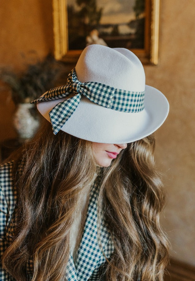 Delicate lucid white fedora hat with wide plaid band.