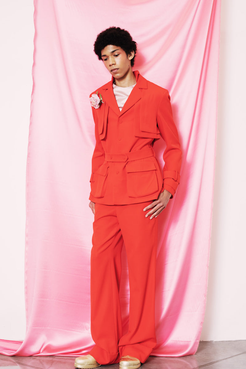 Light scarlet safari style jacket with a buttoned belt and two front pockets.