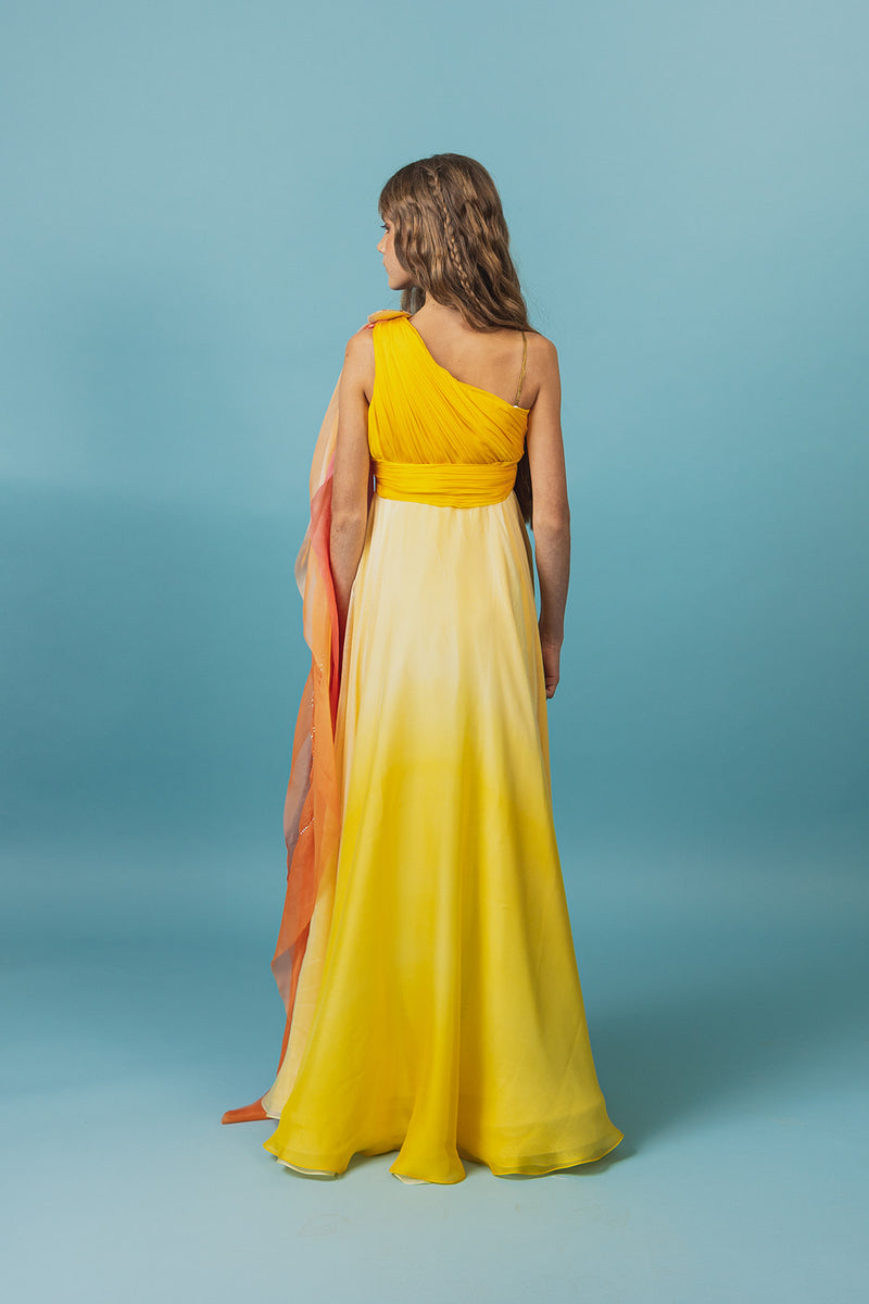 Elegantly soft, sunset-colored one-shoulder empire silk gown.
