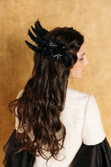 Elegant black swan feather accessory with crystals.