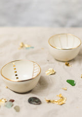 This delicately handcrafted porcelain bowl is adorned with a hand-painted golden motif of the Golden City.