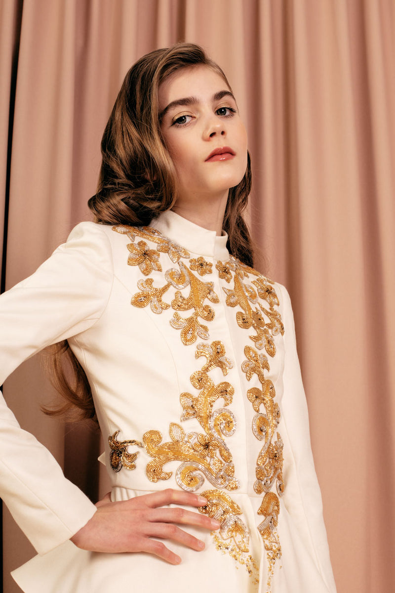 Luxurious mandarin-collar wool and silk jacket with unique Basque-stitch embroidery.