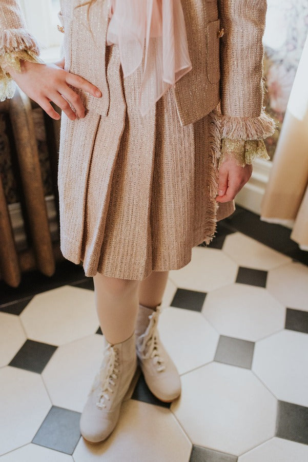 Pleated golden-rose tweed skirt.