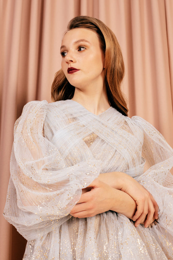 Glamorous glittery sheer blouse made of misty white tulle and lined with 100 % silk.