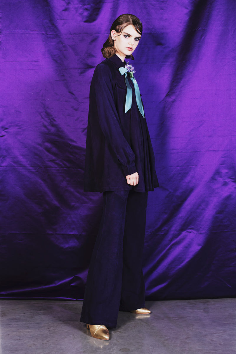 Wide leg deep purple suede trousers with a 100 % silk lining.