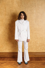 White denim boot-leg trousers with two side pockets, button and zipper in the front.