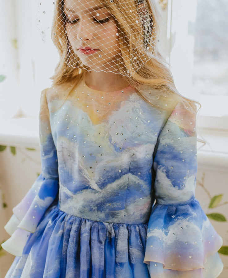 The Magical Sunrise dress is a true collector’s item, completely hand-painted silk by Aristocrat Kids founder and creative director Dace Samite